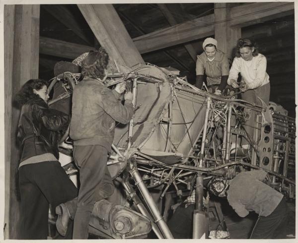 Photo of Women students in the war-training program working on an airplane, 1940s
