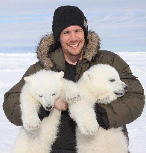 John Whiteman holding polar bear cubs