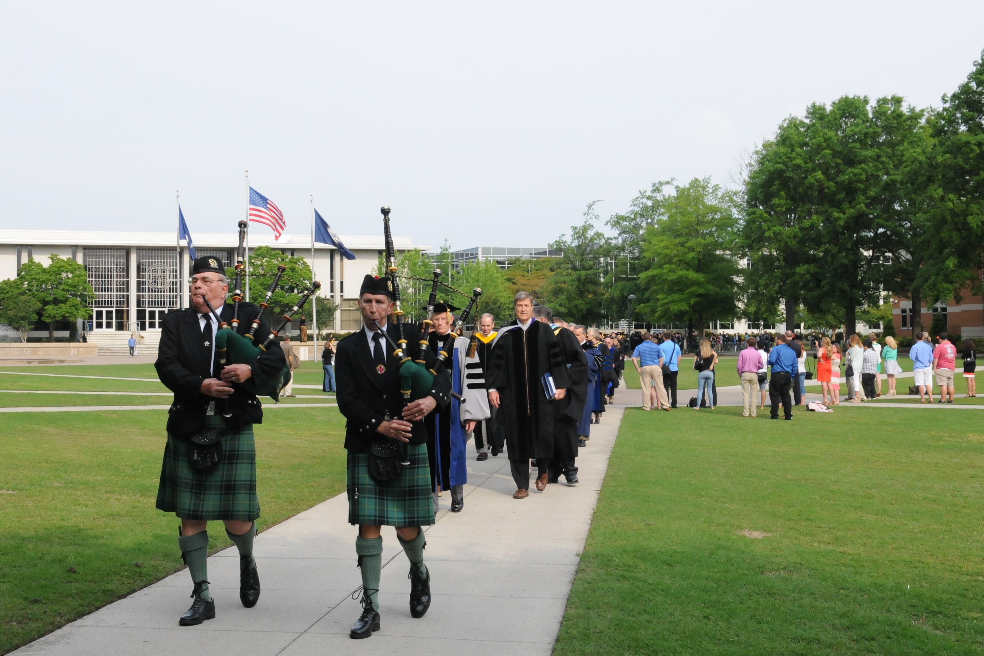 The academic processional walks down Kaufman Mall during spring commencement 2013