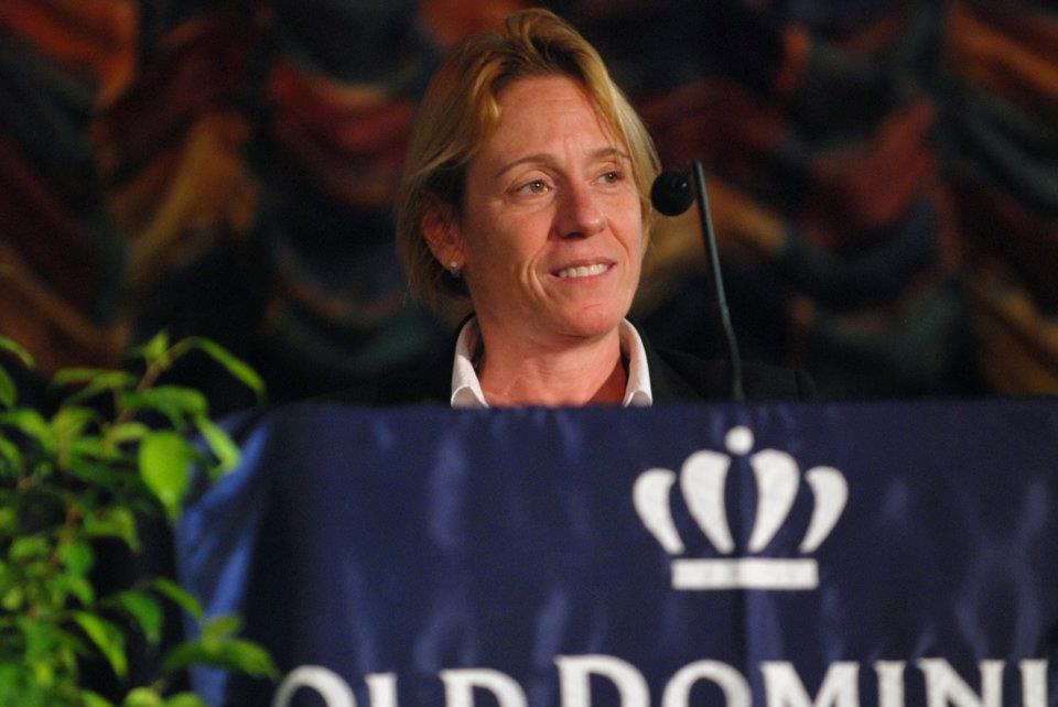 ODU professor Dana Heller standing behind a podium