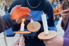 Attendees are given candles near the end of the Solidarity for Ukraine vigil. Photo Amber Kennedy/ODU