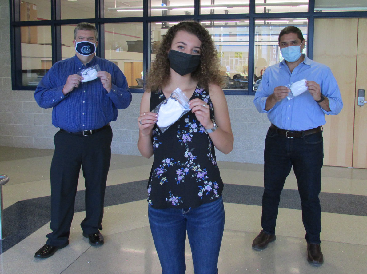 Engineering student Jordan Locklear holding up masks she sewed