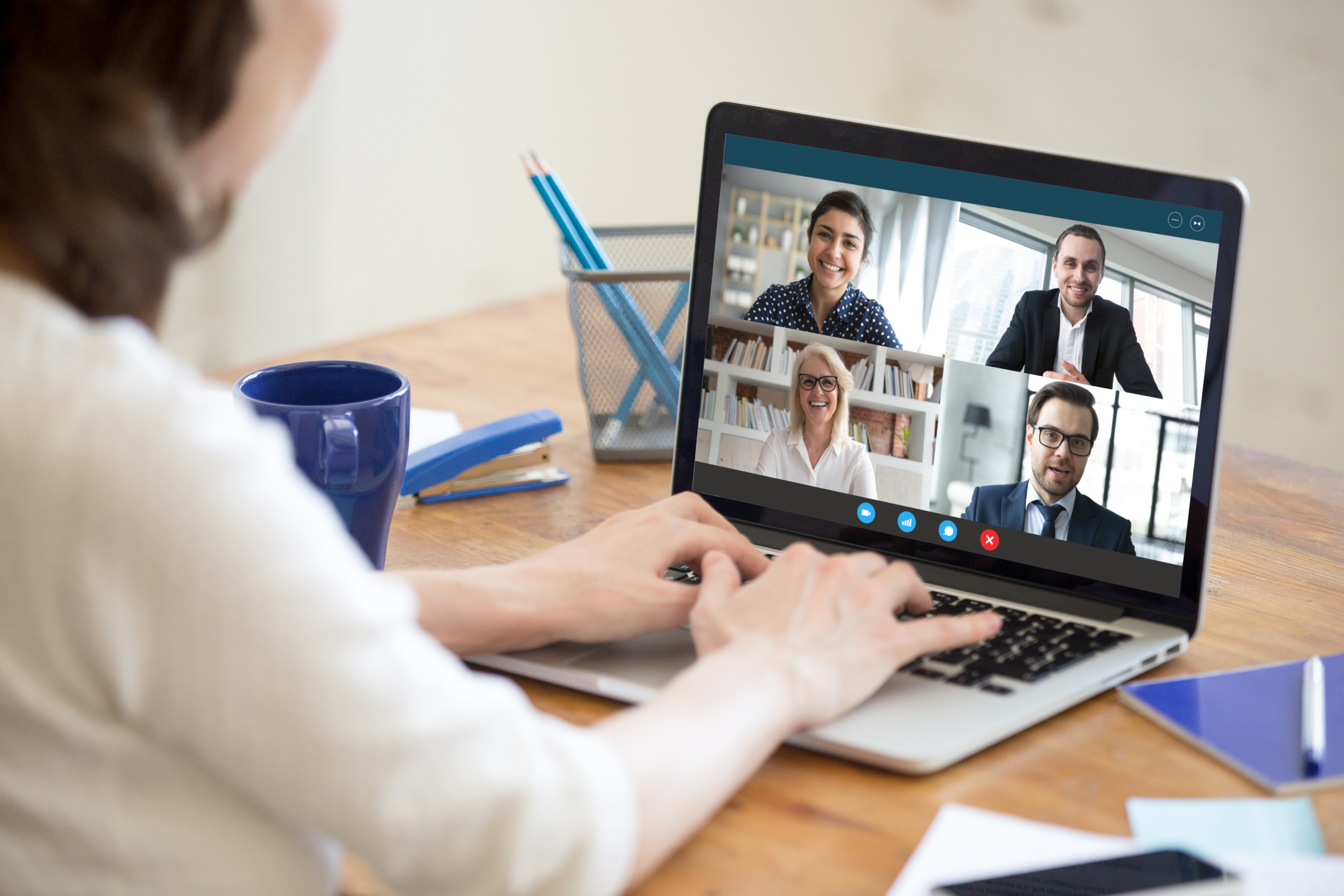 Woman working from home participating in group video call