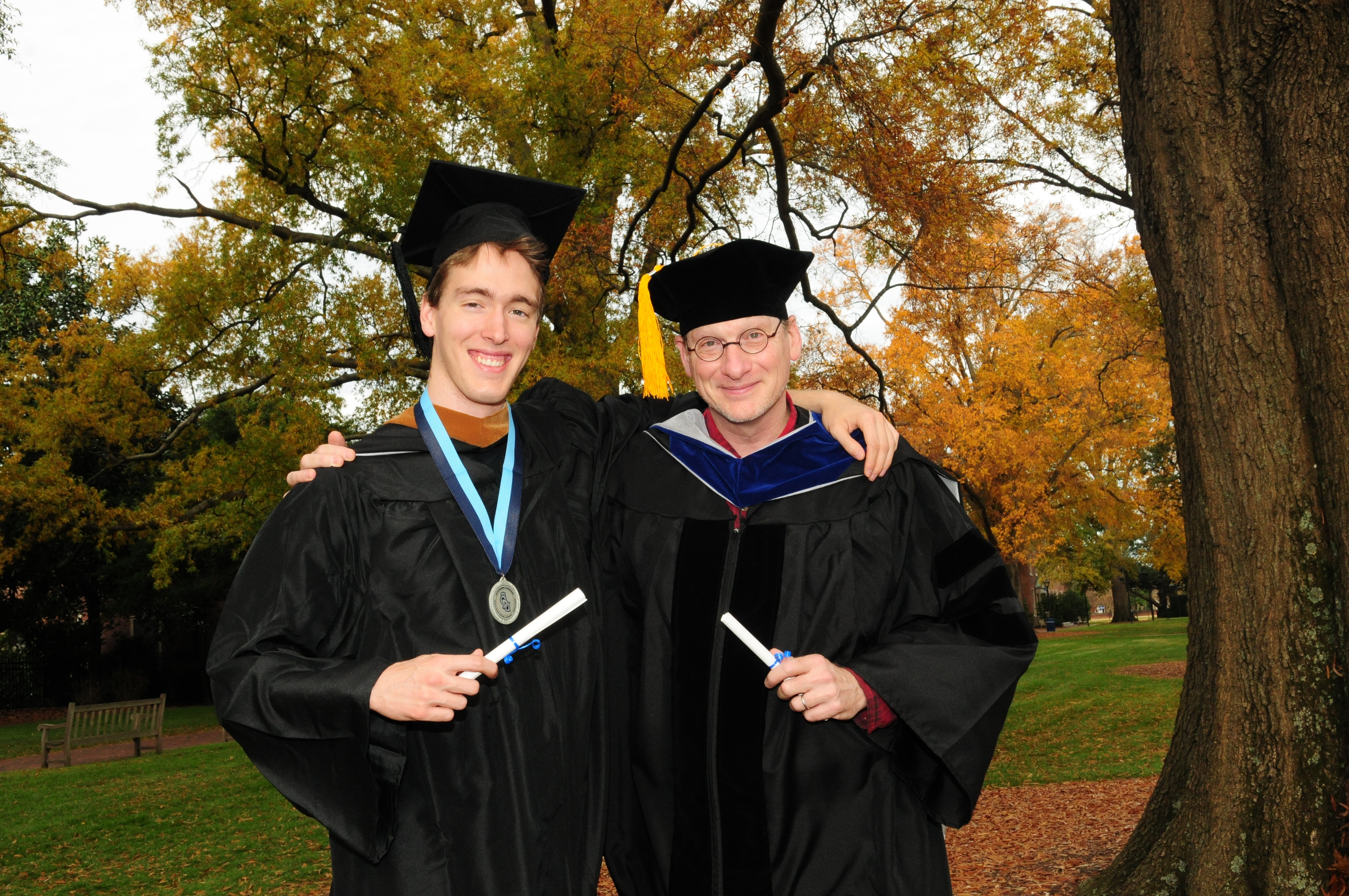photo of son Wilson and father Martin Smith-Rodden in caps and gowns