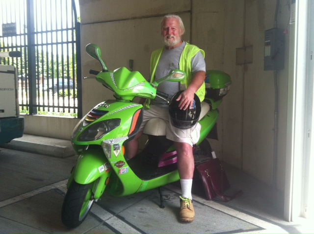 Photo of Richard Riddle on scooter