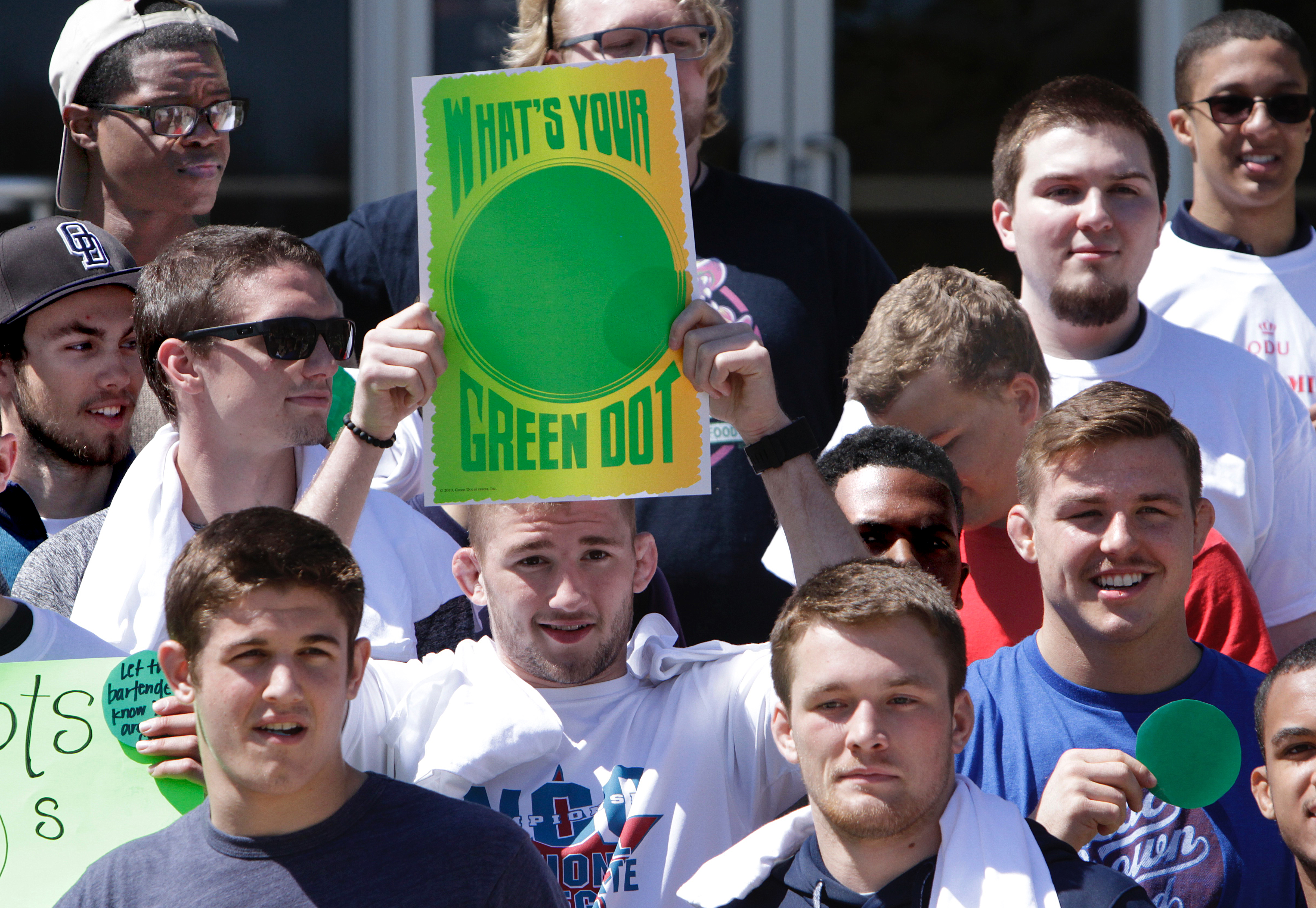 Photo of student holding Green Dot strategy sign