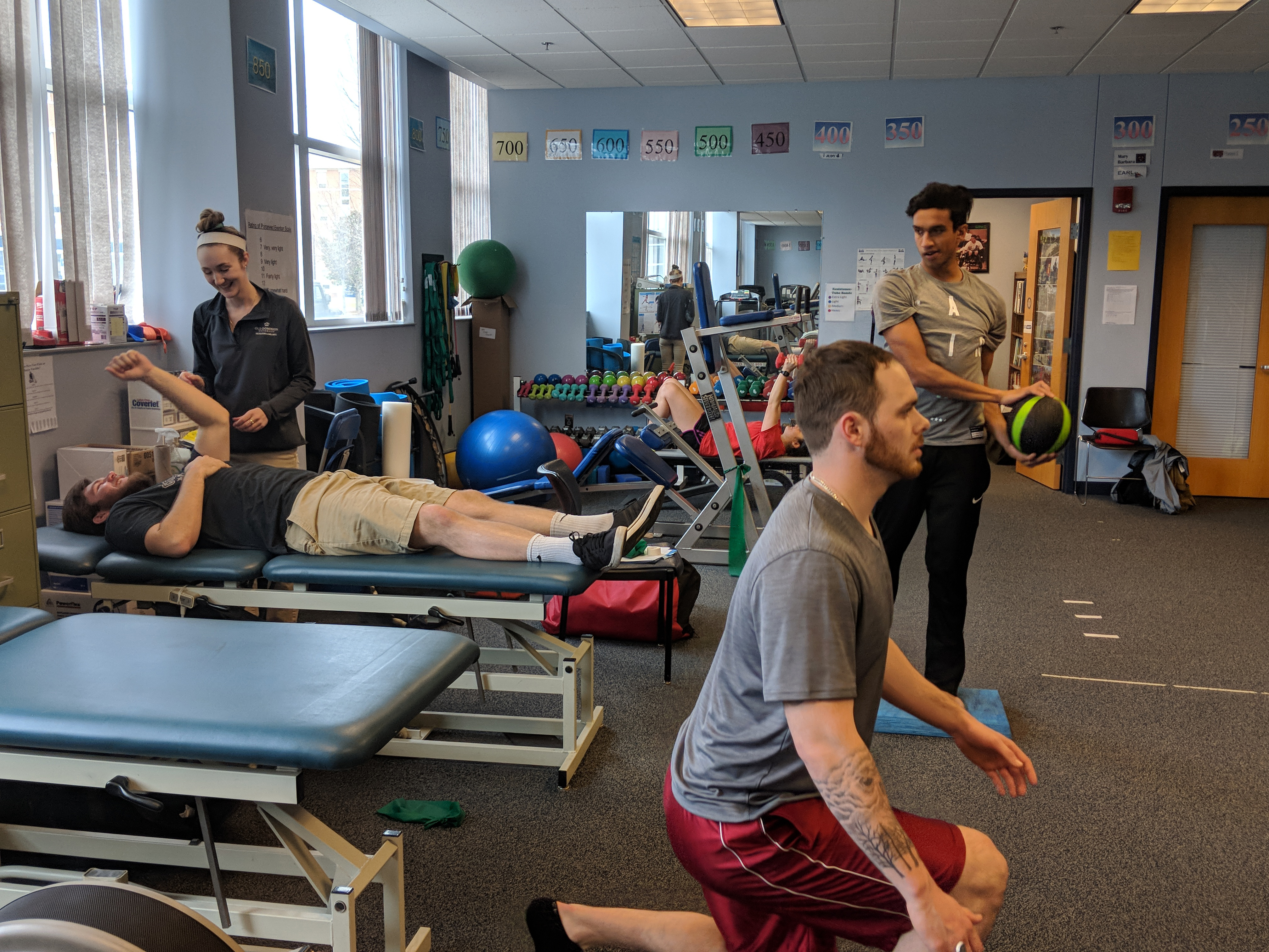 Photo of The Club Sports athletic training room in the Student Recreation Center, which stays busy throughout the week. From left, Jackson Wall, Ariana Moran, Madalynn Grounds, Brady Battenfield and Nareed Asghar.