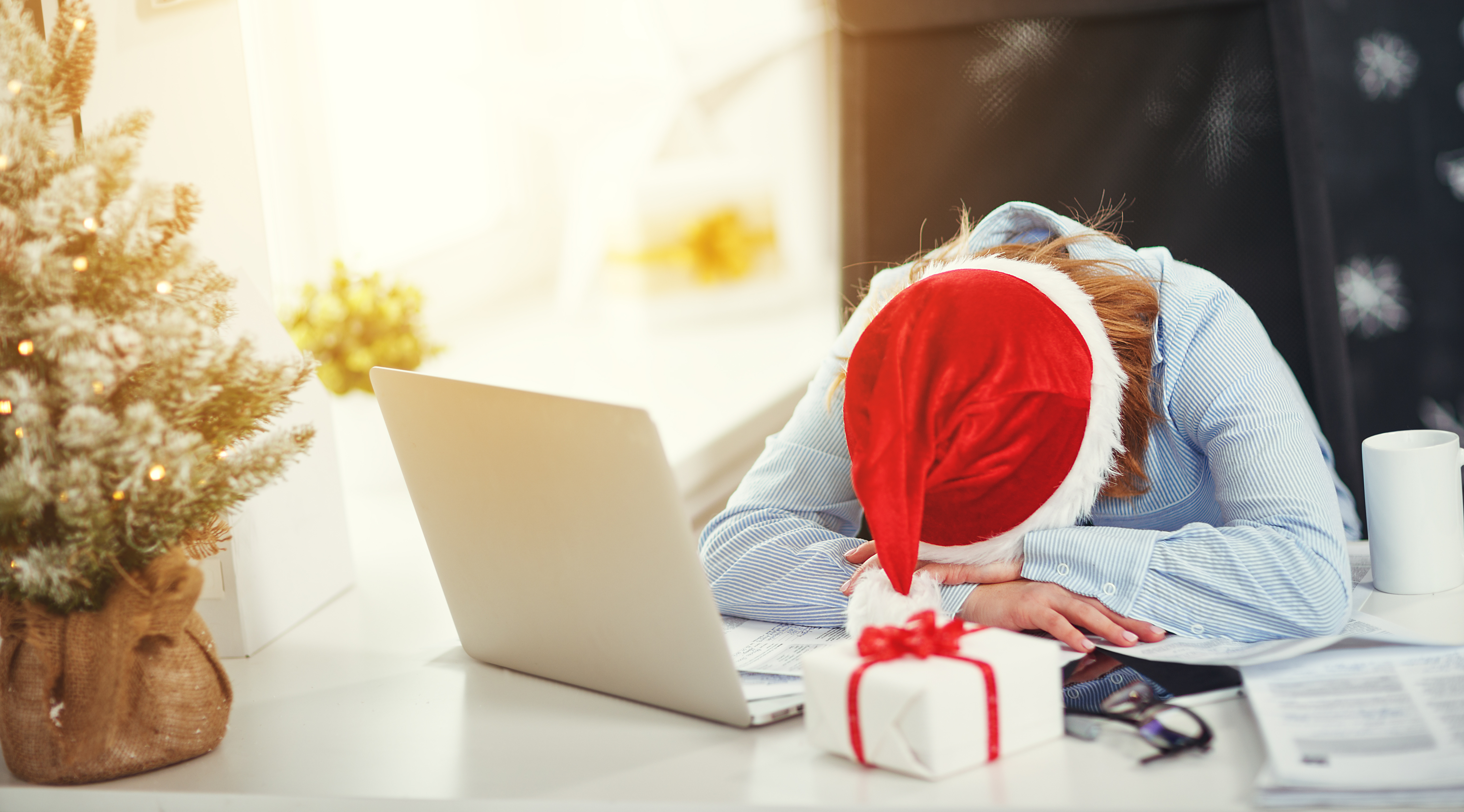 businesswoman freelancer tired, asleep working at computer at Christmas