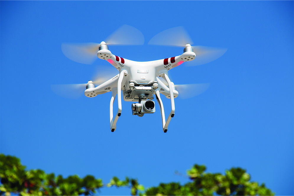 drone-flying-against-blue-sky