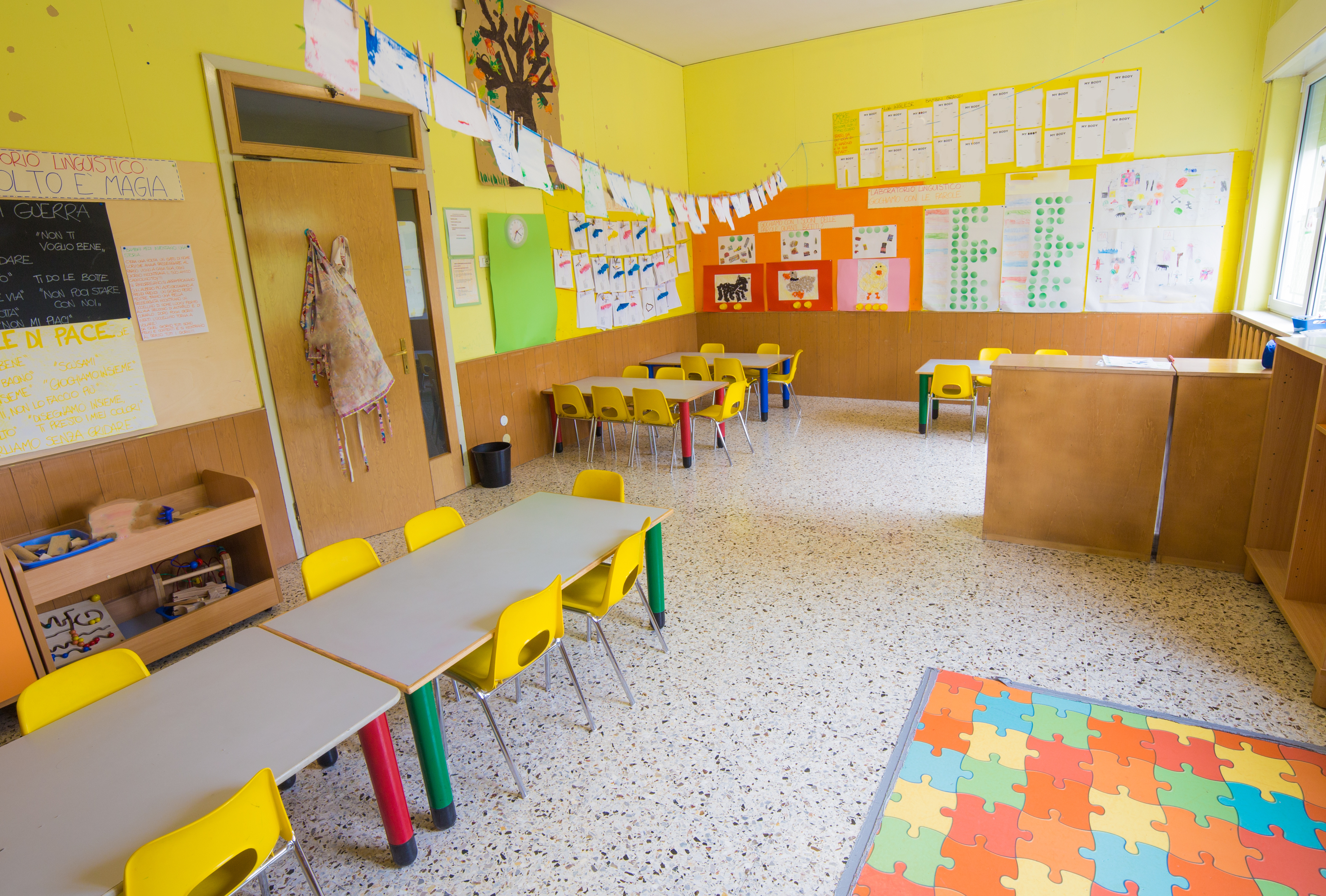 Kindergarten classroom with tables and chairs.