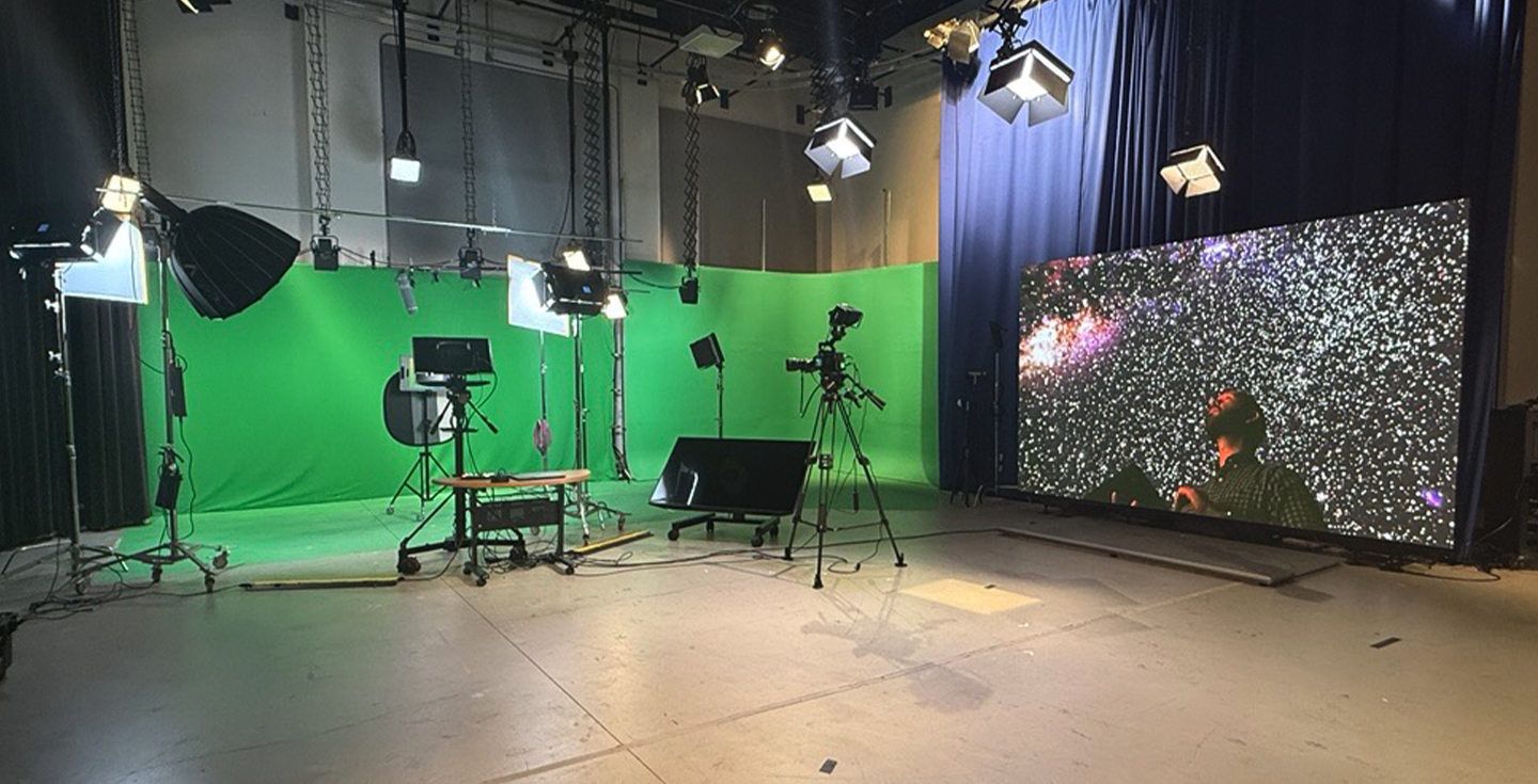 studio space with green screen, lights, and cameras