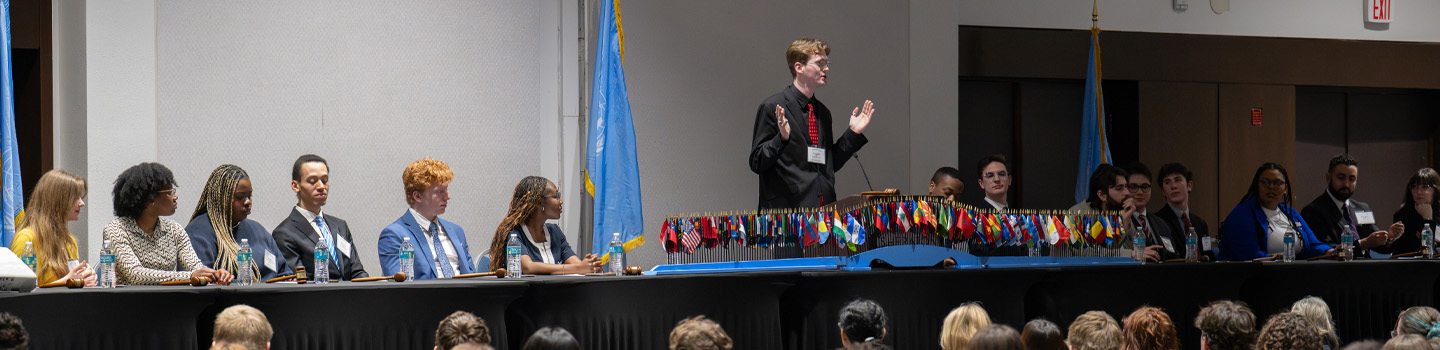 ODU Model United Nations Student Panel presents on stage in front of large audience.