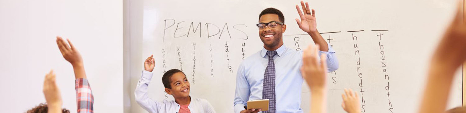 Black male teacher leads a class of elementary-age students
