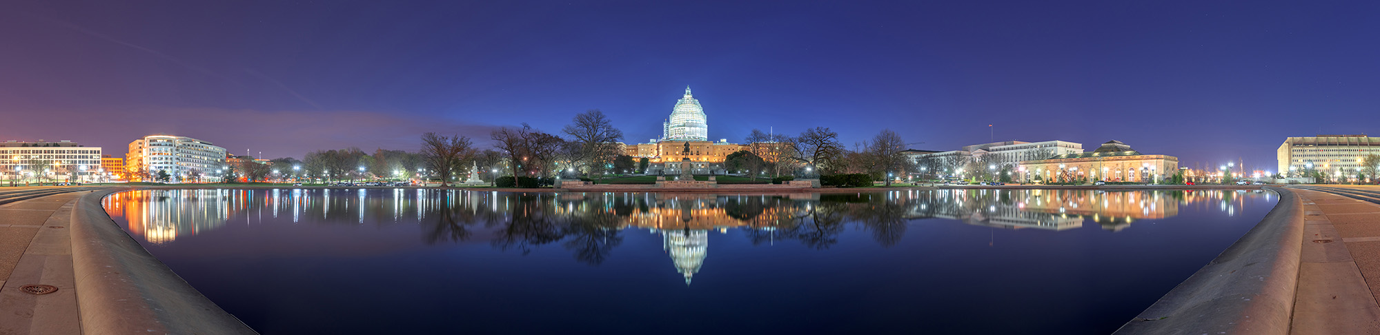 U.S. Capitol Building at night reflected in water