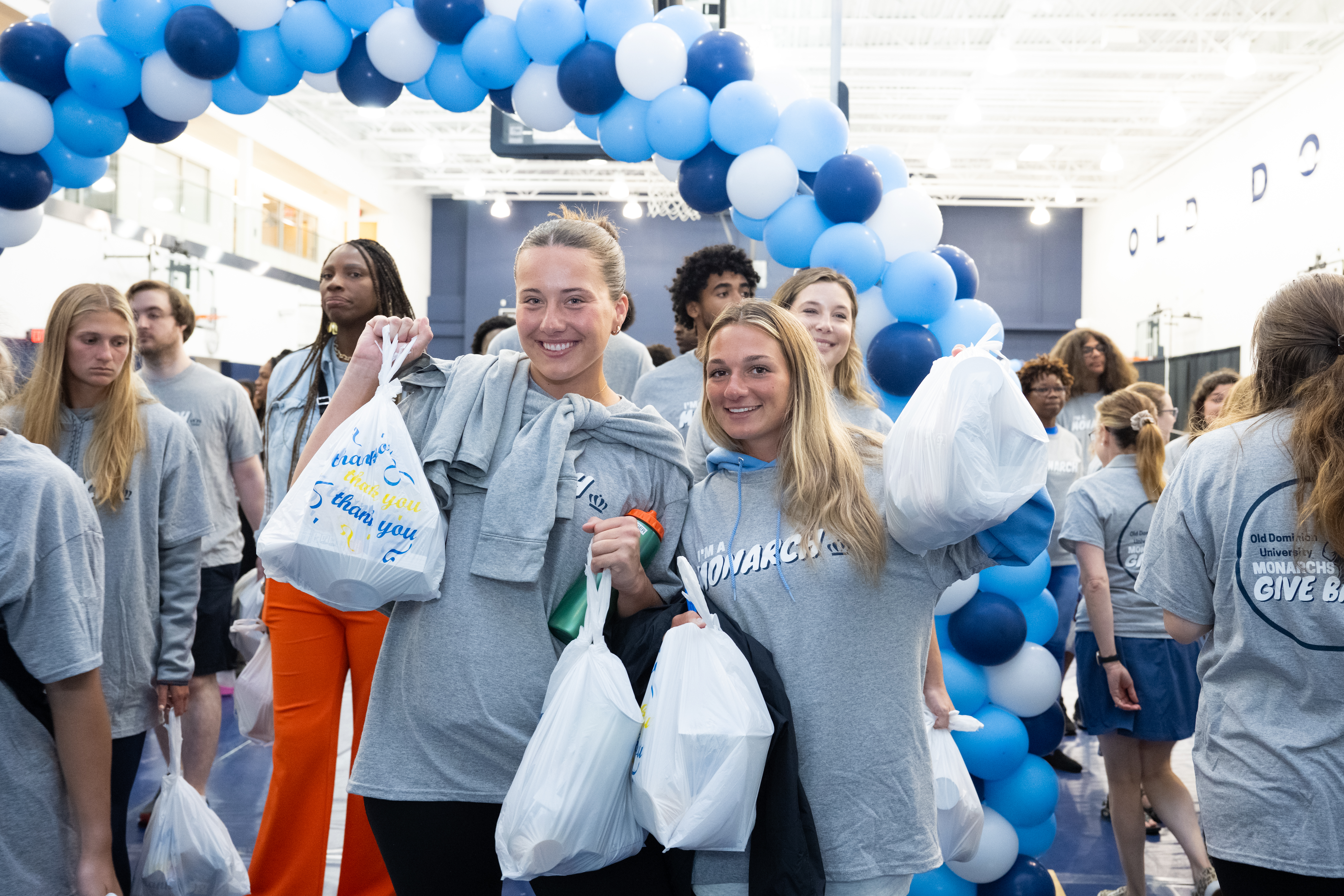 students holding donation bags
