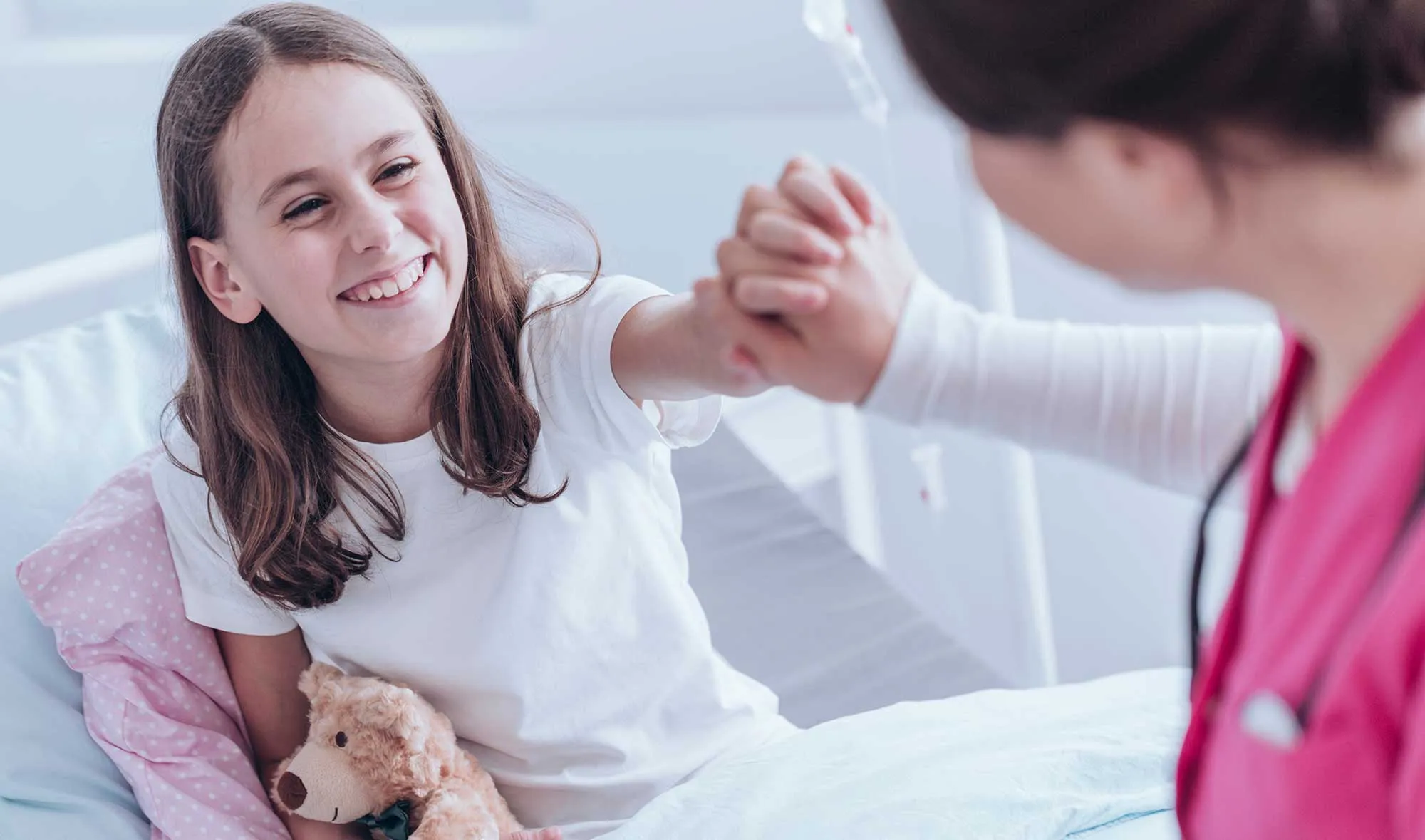 A fellow works with a patient in the ICU.