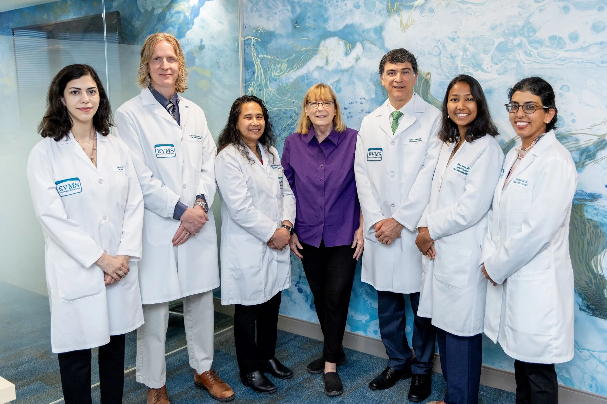 Six doctors and one administrator smile at the camera