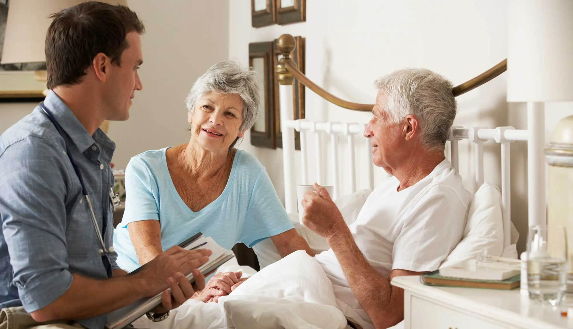 A trainee works with a couple in hospice.