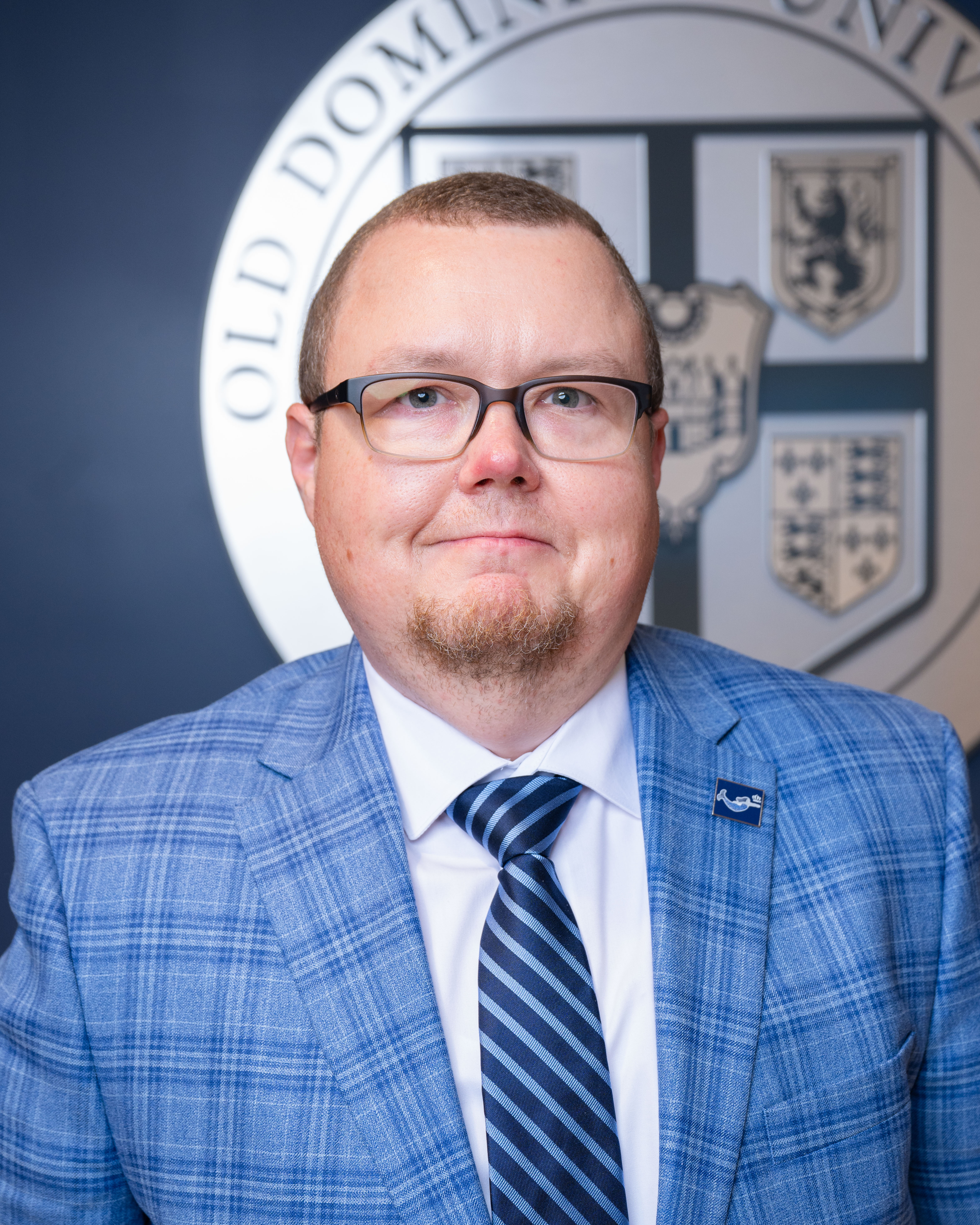 John Adams in front of ODU seal