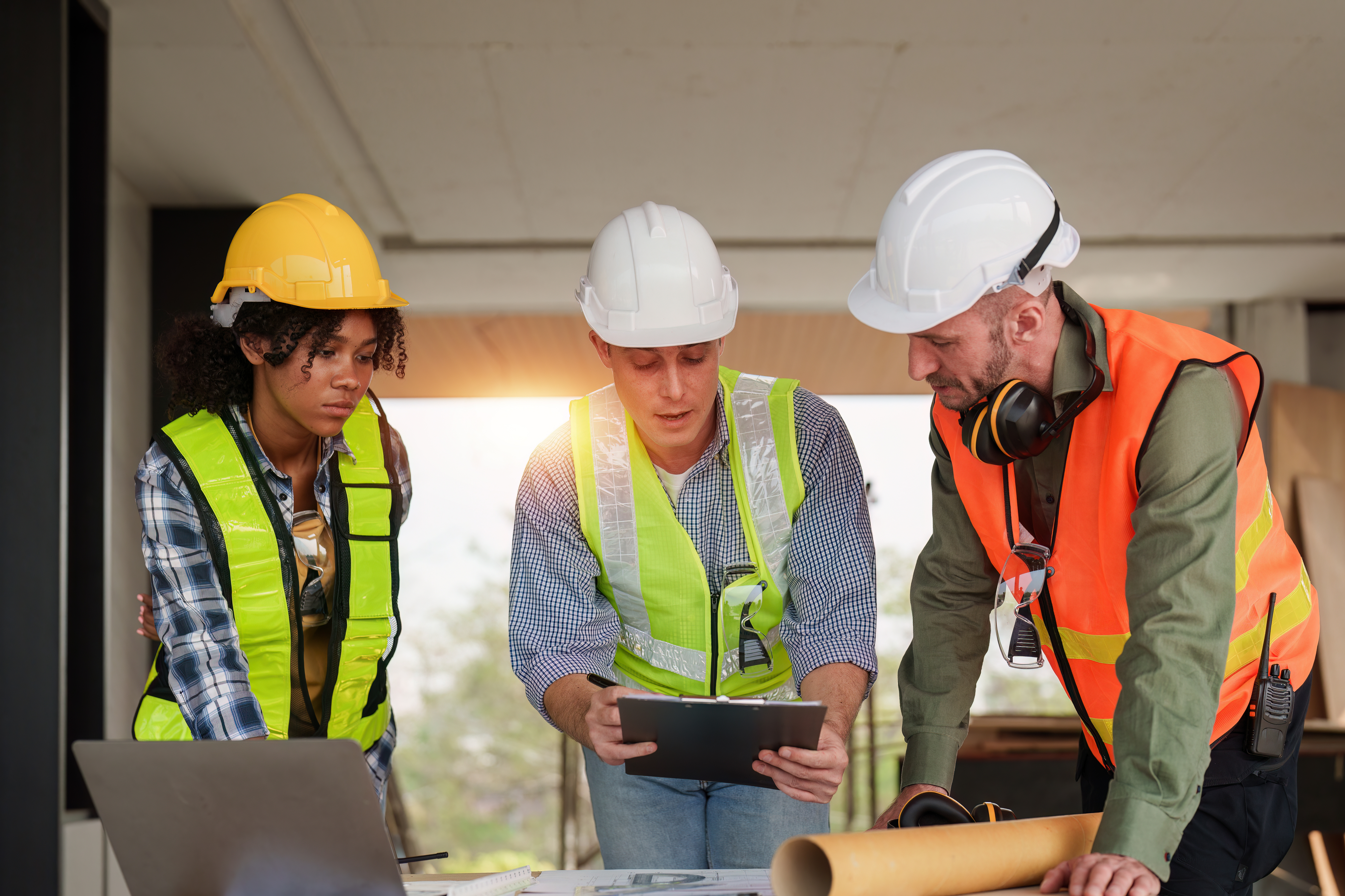 Architect team working with blueprints for architectural plan, engineer sketching a construction project