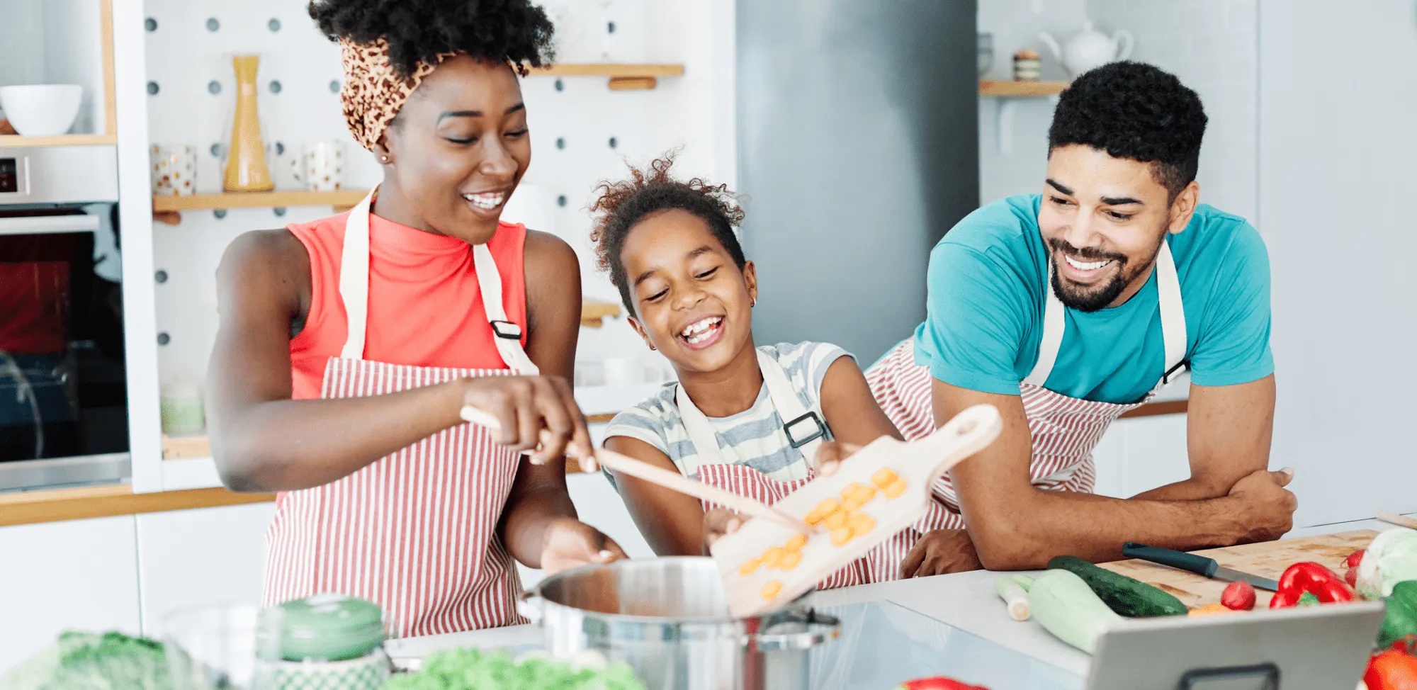 Family preparing a healthy meal and having fun in the kitche