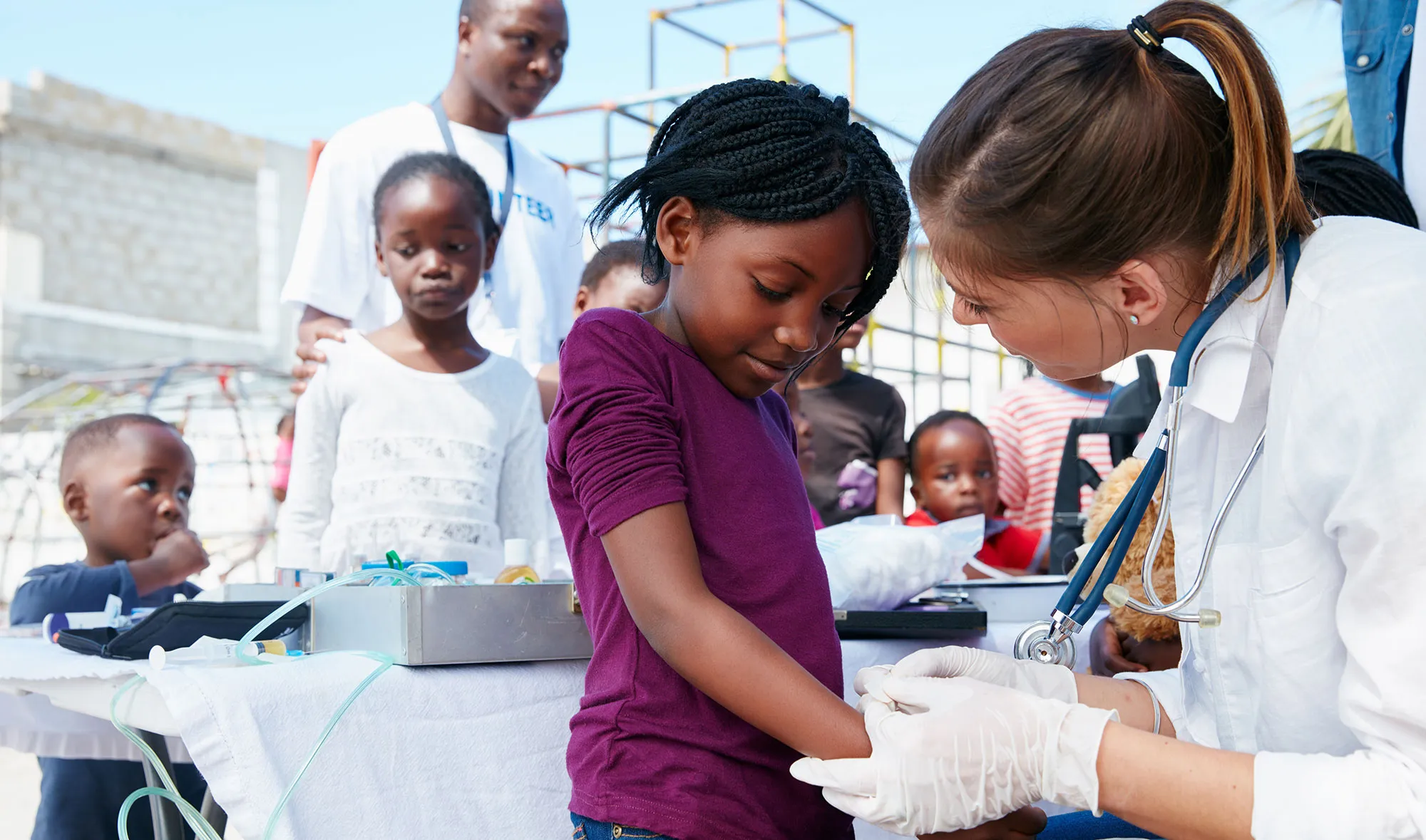 A fellow works with a child.