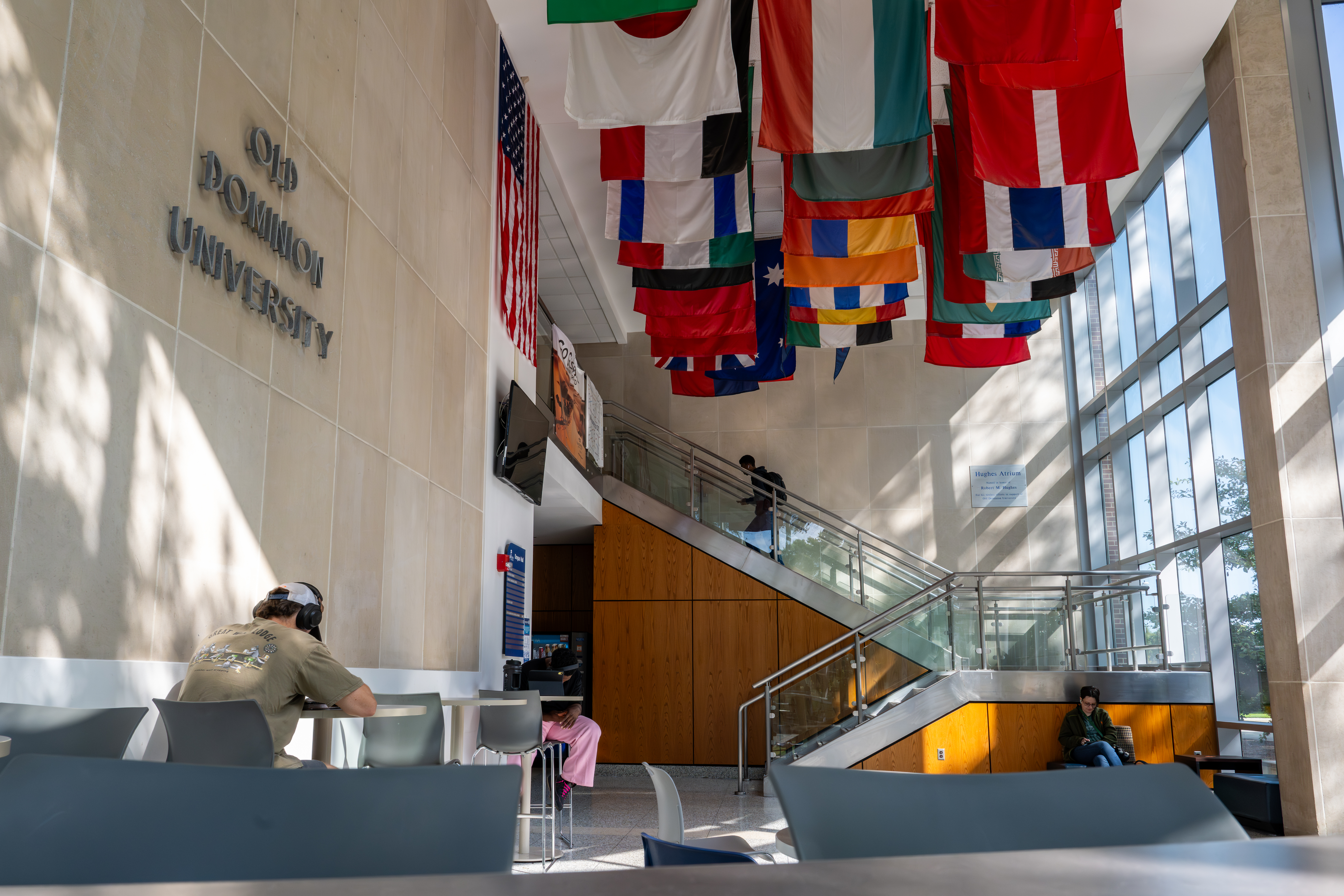 Students sit with laptops in large, two-story lobby at Old Dominion University.