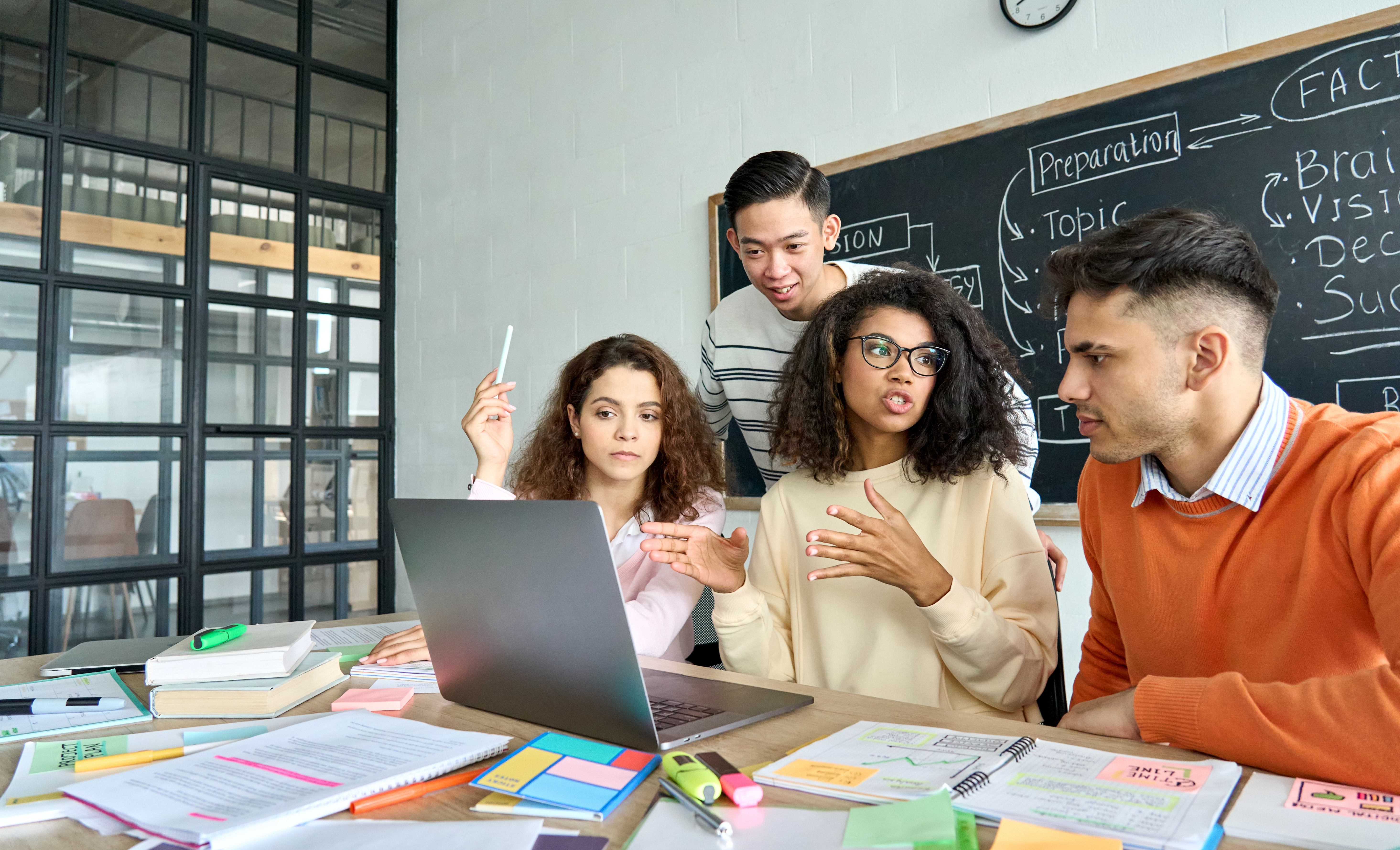 Young professionals discuss project in office meeting room
