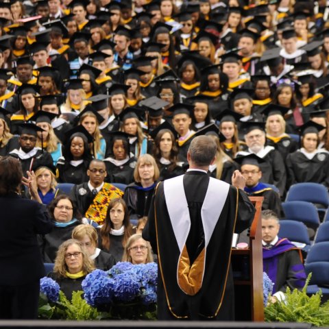 a staduim full of ODU graduates sit and listen to the commencement speech