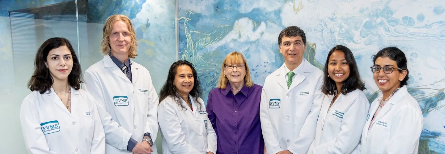 Six doctors and one administrator smile at the camera
