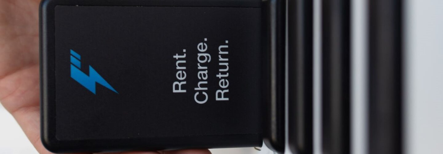 hand inserting battery into slot