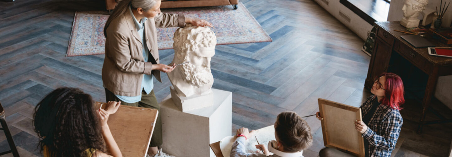 Art teacher and students have class in art studio