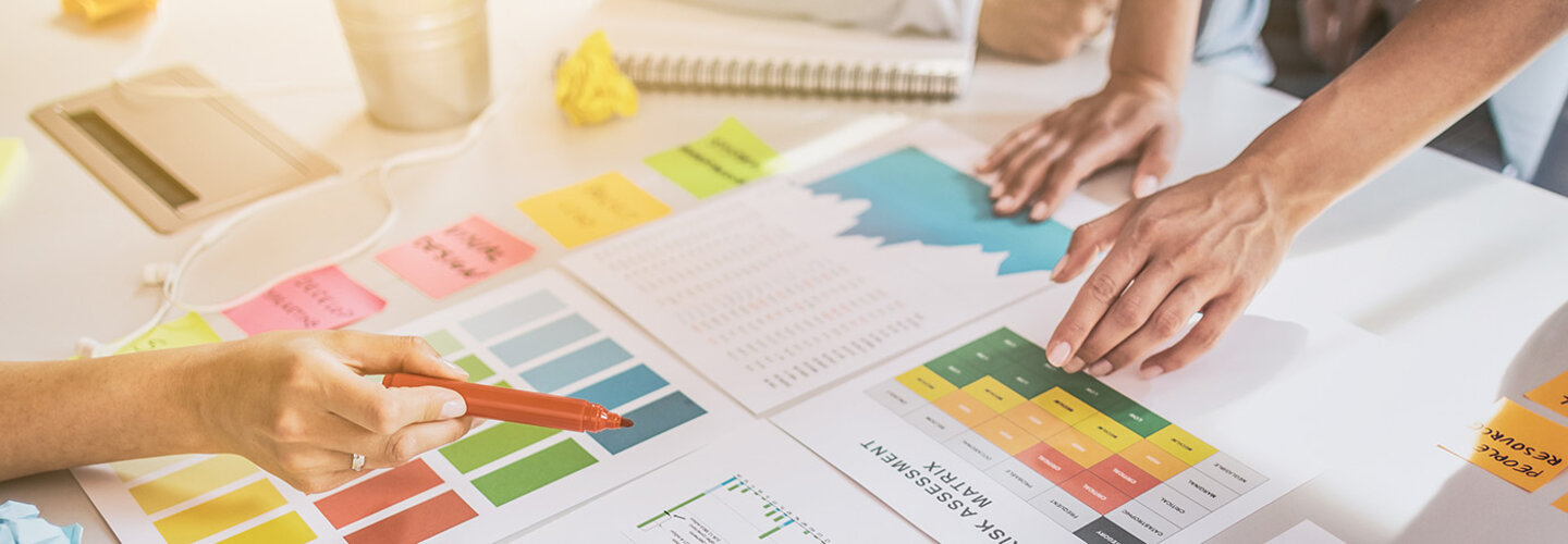Marketing Hands at table reviewing charts