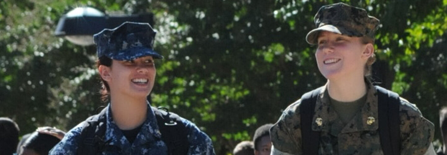 Midshipmen, both female in uniform, walking to class