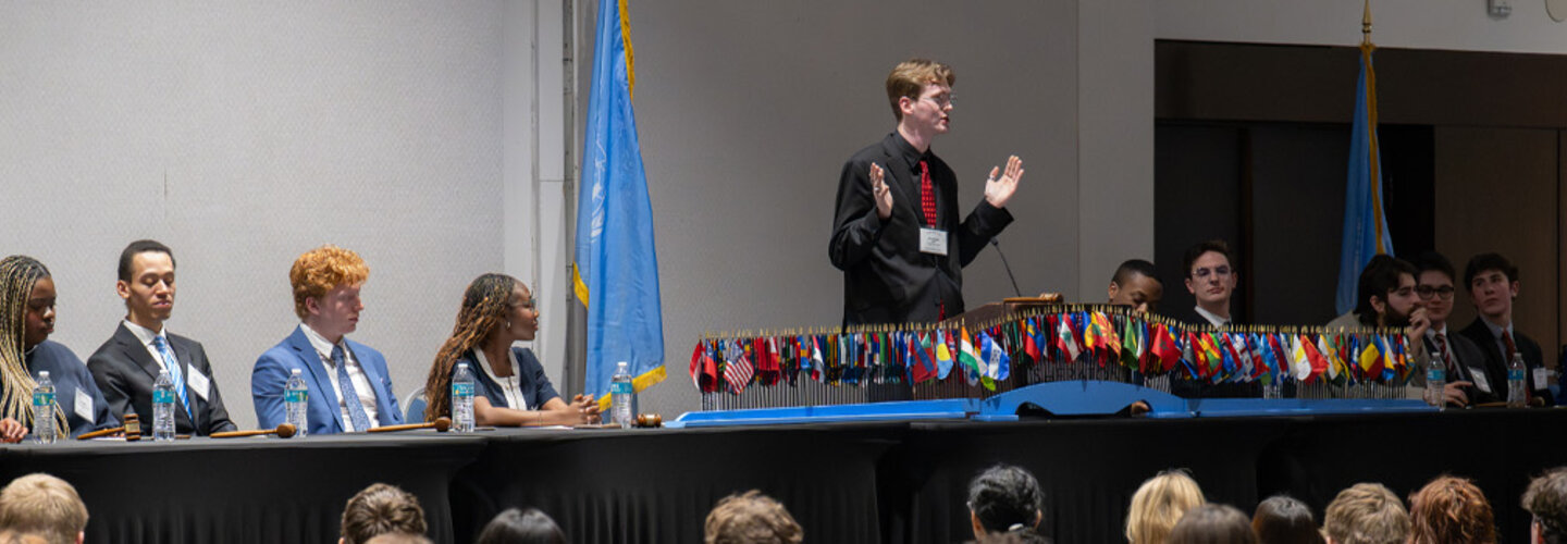 ODU Model United Nations Student Panel presents on stage in front of large audience.