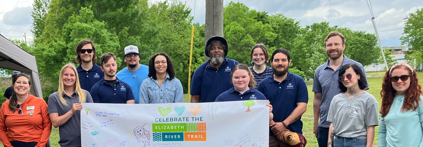 Students & Faculty with an Elizabeth River Project Sign
