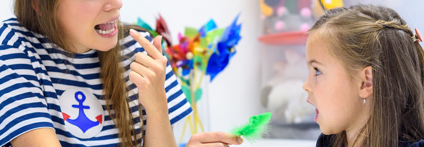 Speech pathologist working with young girl
