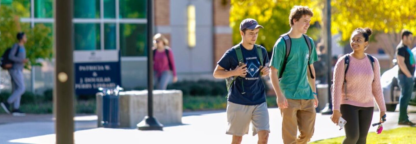 Students Walking Across Campus Banner