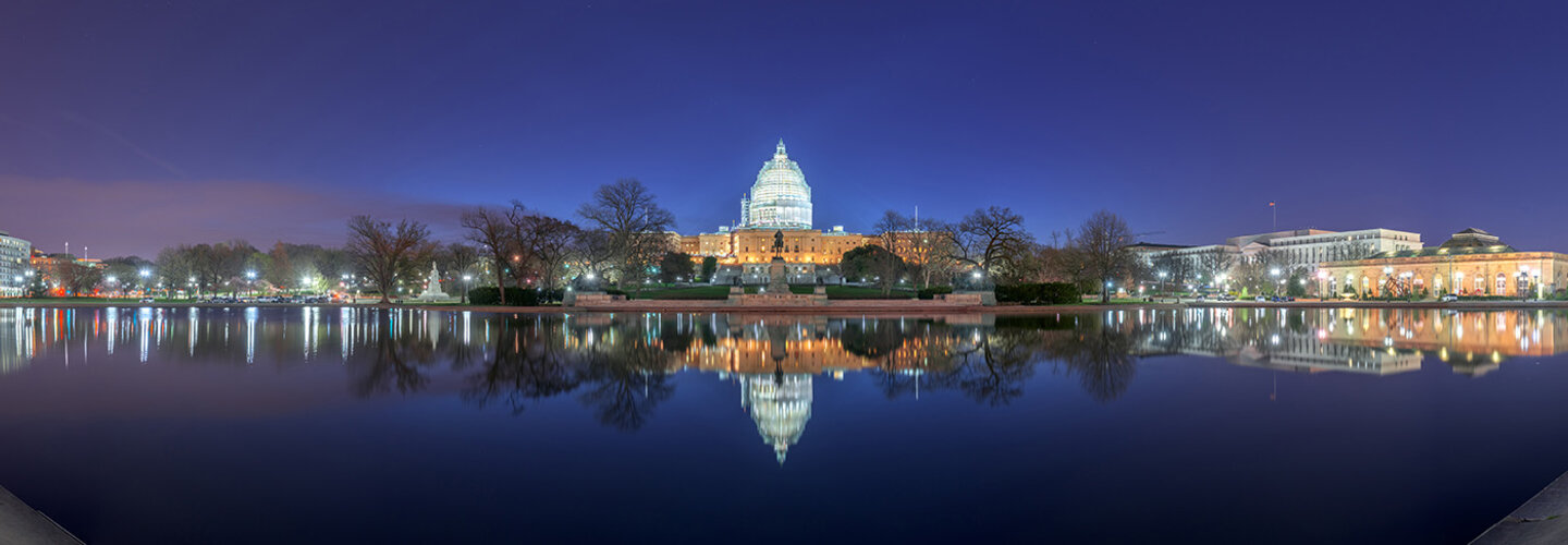 U.S. Capitol Building at night reflected in water