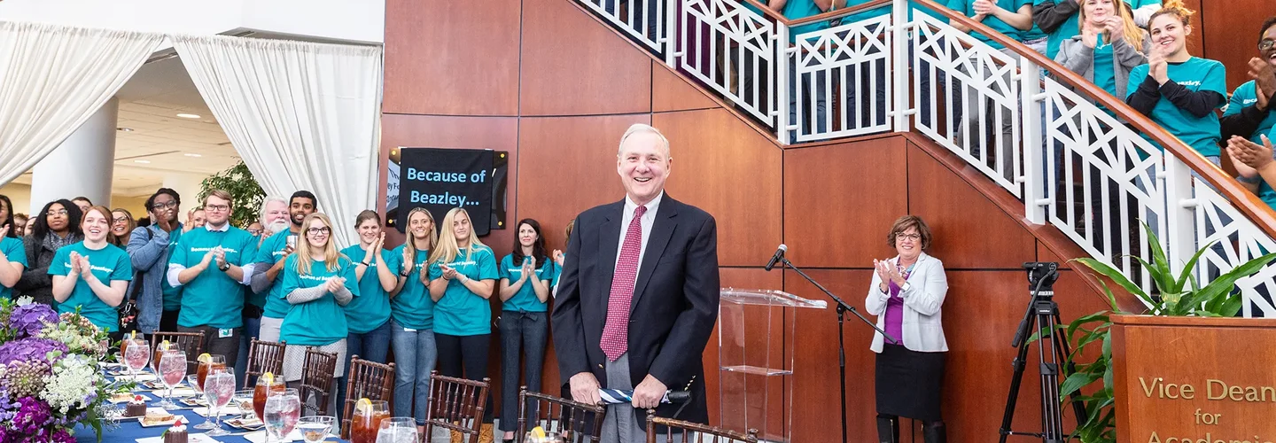 Judge Richard Bray stands in the center while dozens of stud