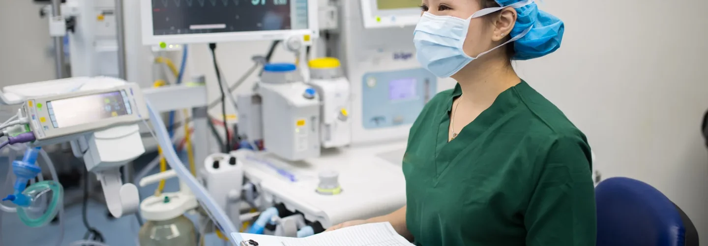 Doctor in green scrubs wearing a mask