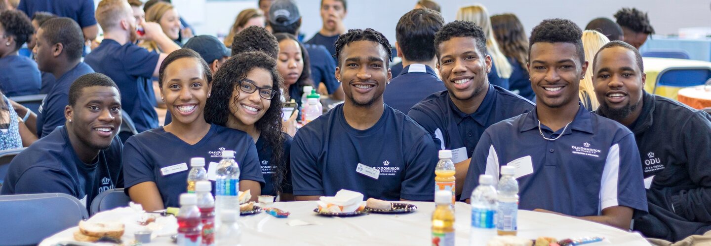 A group of students all dressed in a blue golf top with the ODU logo. 