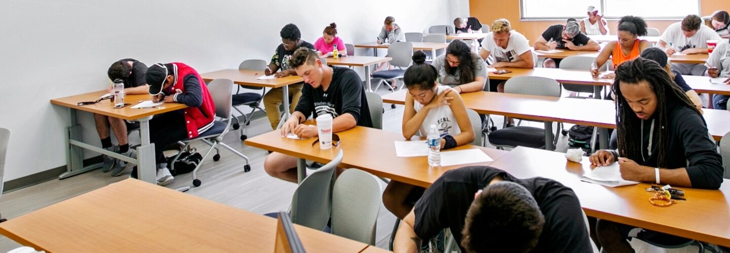 Banner image of a classroom filled with students in desks.