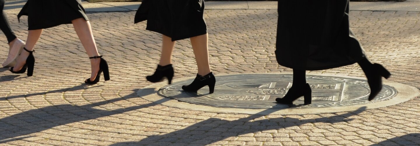 ODU graduates walking across the seal. 