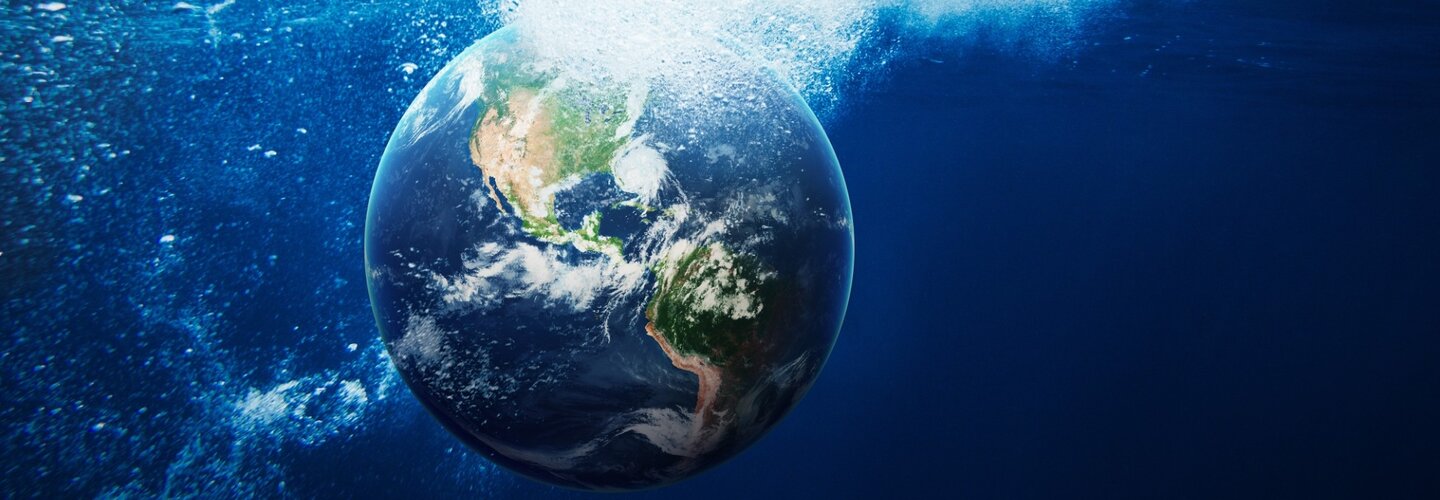 A globe being dropped into water.