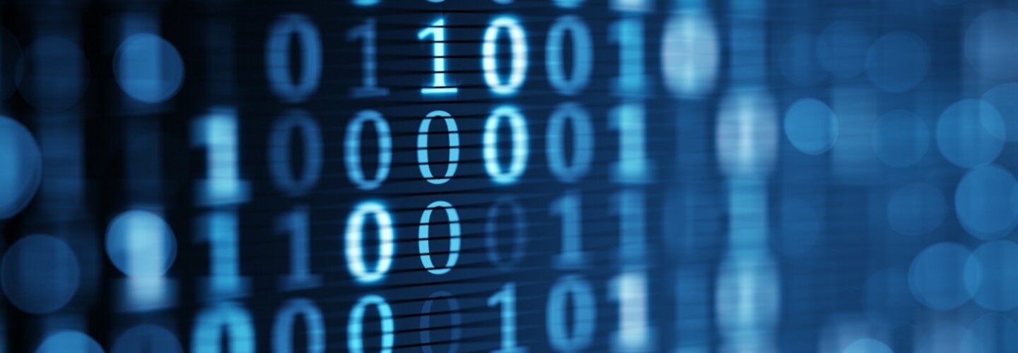 blue digital binary data on computer screen. Close-up shallow DOF