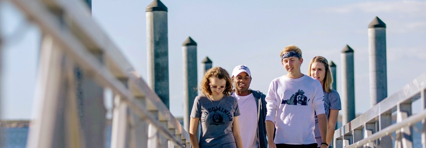 Student talking with friends at Whitehurst Beach.