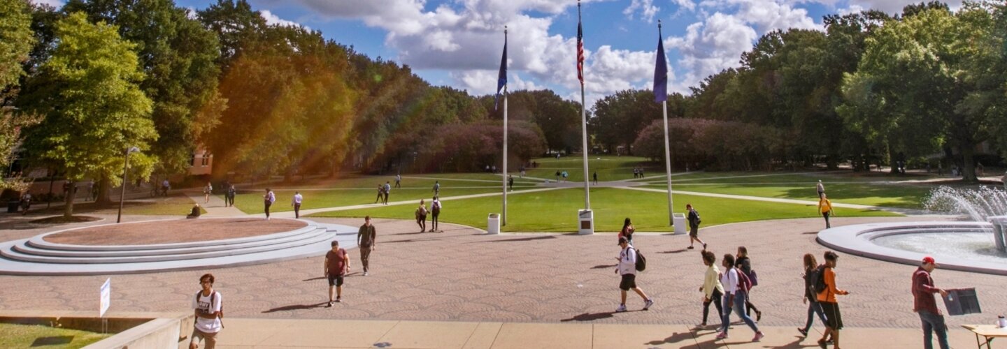 Students cross Kaufman Mall on a summer day