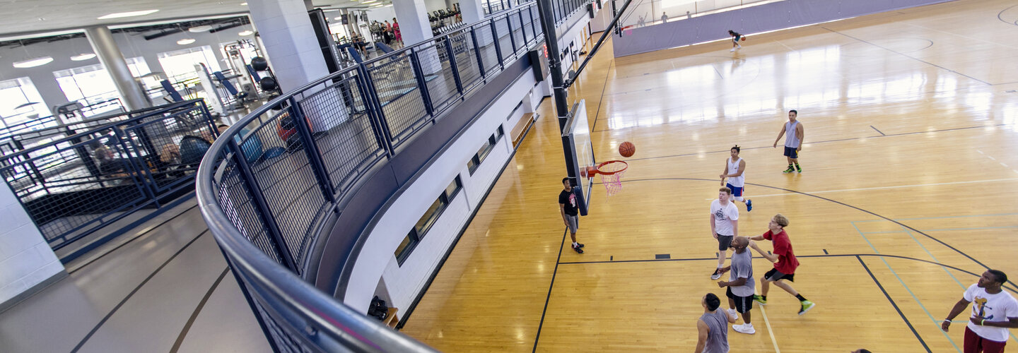 Rec Well basketball court with students playing. 