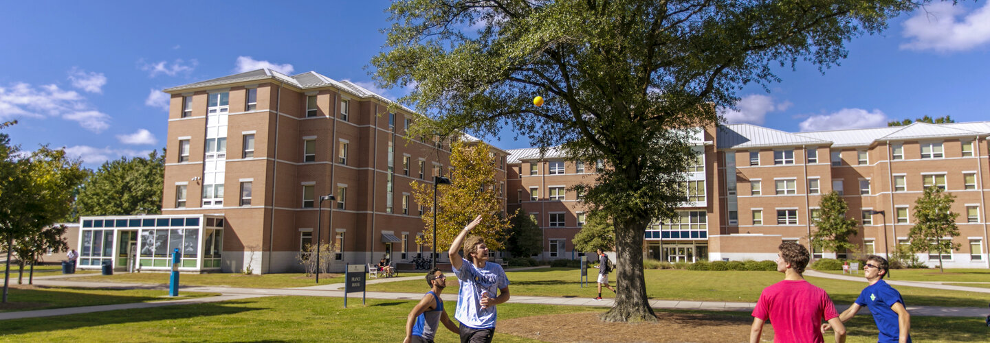 Students playing intramural sports in courtyard. 